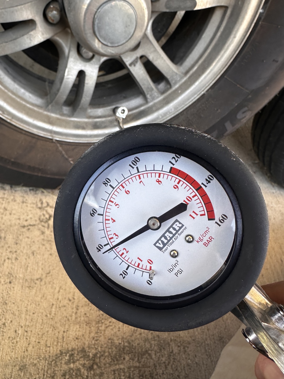 Pressure gauge reading trailer tire at pre-haul inspection &mdash; Mission Ready RV Services