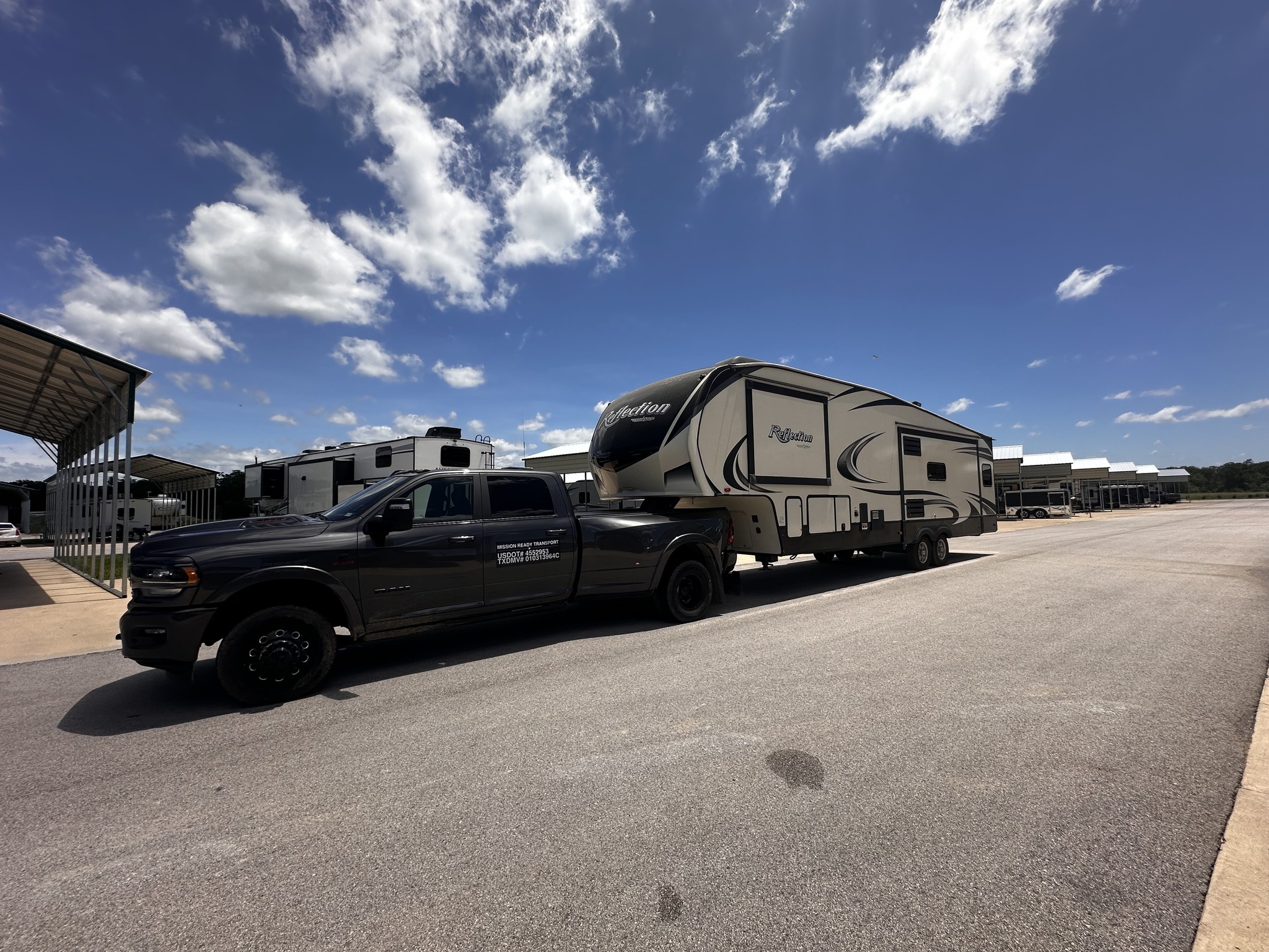 Mission Ready Transport truck with gooseneck hitch moving a fifth wheel between RV campgrounds